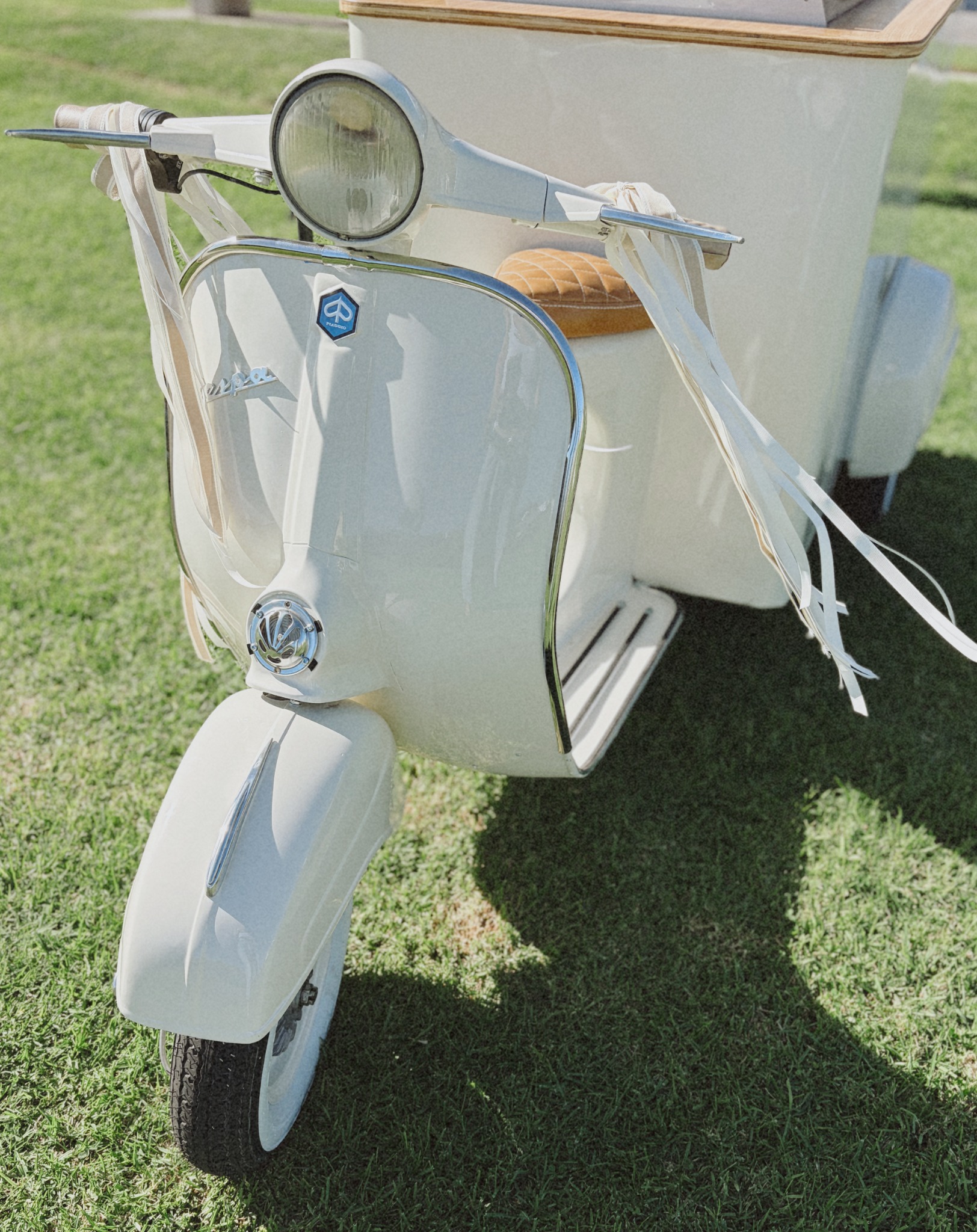 Front of vintage Vespa with handlebars and ribbons